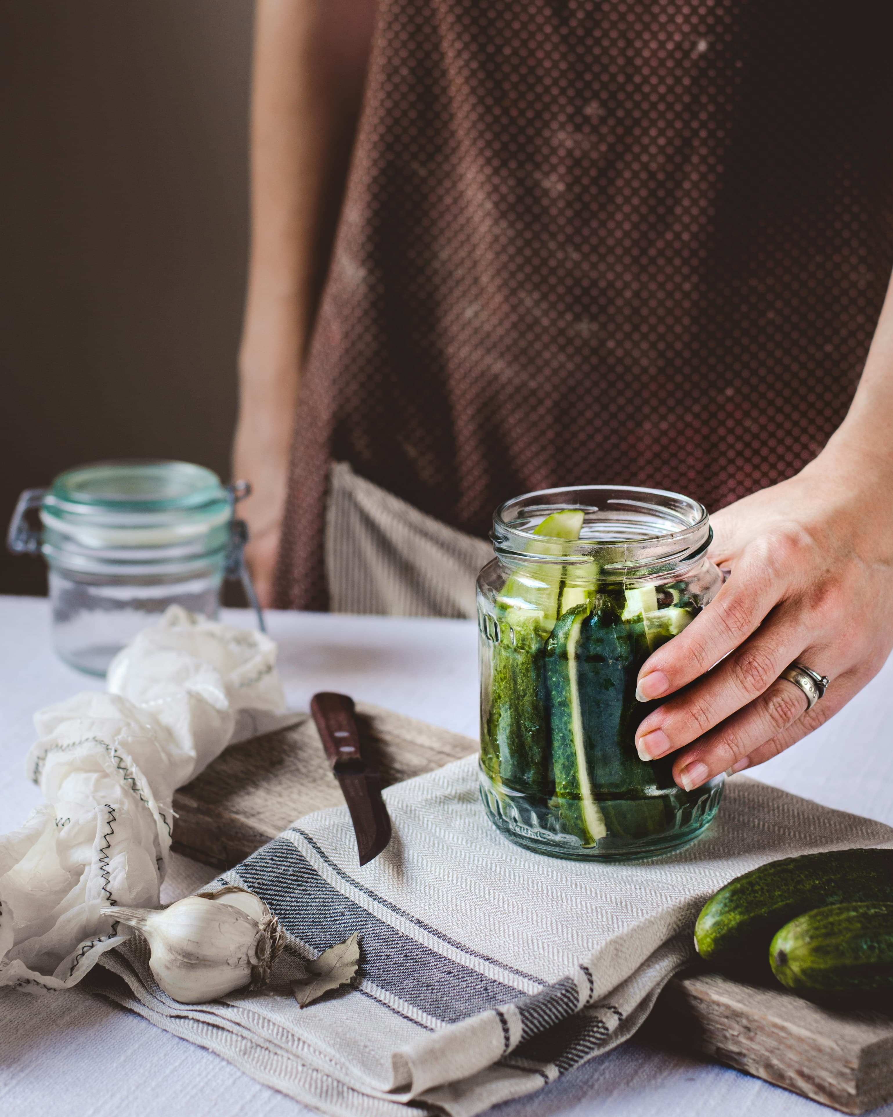 Naturally fermented dill pickles in a glass jar with garlic and dill